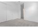 A spacious bedroom with modern doors and neutral carpet at 18453 W Elwood St, Goodyear, AZ 85338