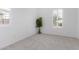 A bedroom with white shutters over the windows and neutral carpet at 18453 W Elwood St, Goodyear, AZ 85338