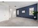 Spacious bedroom featuring a dark blue accent wall and carpet flooring at 18453 W Elwood St, Goodyear, AZ 85338