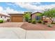 Beautiful single-story home featuring a desert landscaped yard, tile roof and a two car garage at 18453 W Elwood St, Goodyear, AZ 85338