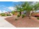 A charming, single-story home with desert landscaping, a brick driveway, and neutral exterior paint at 18453 W Elwood St, Goodyear, AZ 85338