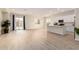 Open-concept living space features light wood flooring and access to the home's backyard at 18453 W Elwood St, Goodyear, AZ 85338