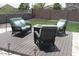 Outdoor backyard seating on a wooden deck, with a fire pit and desert landscaping at 18599 W Illini St, Goodyear, AZ 85338