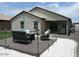 Outdoor backyard with patio, seating, barbecue and desert landscaping surrounding the home at 18599 W Illini St, Goodyear, AZ 85338