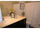 Bathroom featuring a sleek vanity with black cabinets and a combined tub and shower at 18599 W Illini St, Goodyear, AZ 85338