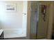 Bathroom featuring a combined tub and shower with glass door at 18599 W Illini St, Goodyear, AZ 85338