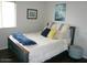 Charming bedroom featuring a comfortable bed and a window providing natural light at 18599 W Illini St, Goodyear, AZ 85338