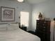 Cozy bedroom featuring a comfortable bed, dresser, and window providing natural light at 18599 W Illini St, Goodyear, AZ 85338