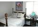 Well-lit bedroom with a four-poster bed and a quaint desk area by the window at 18599 W Illini St, Goodyear, AZ 85338