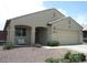 Charming single-story home featuring a two-car garage and covered porch with sitting bench at 18599 W Illini St, Goodyear, AZ 85338