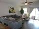 Open living room showcasing modern furniture, ceiling fan, and access to backyard at 18599 W Illini St, Goodyear, AZ 85338