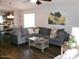 Spacious living room featuring comfortable seating and connecting kitchen area with dining table at 18599 W Illini St, Goodyear, AZ 85338