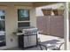 Outdoor grill area with a stainless steel grill and a small dining table at 18599 W Illini St, Goodyear, AZ 85338