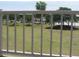Community view of the park area through a white iron fence on a clear day at 18599 W Illini St, Goodyear, AZ 85338