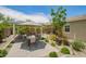 Seating beneath a pergola surrounded by meticulously landscaped grounds perfect for outdoor entertaining or relaxing at 18653 W Mescal St, Surprise, AZ 85388
