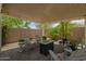 The covered patio area features comfortable seating, a fire pit, and lots of space at 18653 W Mescal St, Surprise, AZ 85388