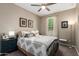 Bright bedroom with a ceiling fan, window with blinds, and neutral decor at 18653 W Mescal St, Surprise, AZ 85388