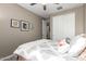Comfortable bedroom with soft carpet, ceiling fan, and view of the closet space at 18653 W Mescal St, Surprise, AZ 85388