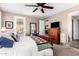 Relaxing bedroom with carpet, ceiling fan, and access to a private patio at 18653 W Mescal St, Surprise, AZ 85388