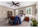 Comfortable bedroom featuring a ceiling fan, plantation shutters, and carpeted flooring at 18653 W Mescal St, Surprise, AZ 85388