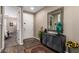 Welcoming foyer features wood-look tile, accent mirror and decorative furnishings at 18653 W Mescal St, Surprise, AZ 85388
