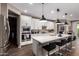 Modern kitchen features a large island, stainless steel appliances, and white cabinetry at 18653 W Mescal St, Surprise, AZ 85388