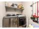 Efficient laundry room with modern washer and dryer units, providing convenience for laundry tasks at 18653 W Mescal St, Surprise, AZ 85388