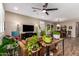 Cozy living room showcasing a ceiling fan, neutral paint, and access to the dining area at 18653 W Mescal St, Surprise, AZ 85388