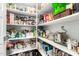 Spacious pantry offering ample storage with well-stocked shelves for food and household items at 18653 W Mescal St, Surprise, AZ 85388