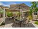 Backyard patio view of dining table and seating area under covered patio at 18653 W Mescal St, Surprise, AZ 85388