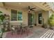 Covered patio with comfortable seating and fan, ideal for outdoor relaxation and gatherings in any weather at 18653 W Mescal St, Surprise, AZ 85388