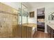 Spa-like bathroom showcasing a tiled shower, soaking tub, and a serene ambiance at 19606 N 23Rd Way, Phoenix, AZ 85024