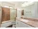 Bathroom with marble countertop, framed mirror and tiled shower at 19606 N 23Rd Way, Phoenix, AZ 85024