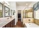 Elegant bathroom featuring double sinks, walk-in closet, and a separate shower and tub at 19606 N 23Rd Way, Phoenix, AZ 85024