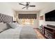 Comfortable bedroom with a tufted headboard, neutral bedding, and fireplace at 19606 N 23Rd Way, Phoenix, AZ 85024