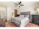 Comfortable bedroom features a ceiling fan, neutral color palette, and barn door to the bathroom at 19606 N 23Rd Way, Phoenix, AZ 85024