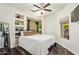 Bedroom with built in shelves, dark wood floors, and two windows that allow natural light to shine through at 19606 N 23Rd Way, Phoenix, AZ 85024