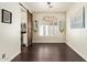 Elegant dining room with a modern chandelier, sliding barn door, and bright natural light at 19606 N 23Rd Way, Phoenix, AZ 85024
