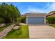 Beautiful single-story home featuring a blue garage door and desert landscaping at 19606 N 23Rd Way, Phoenix, AZ 85024