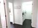 Hallway featuring laundry room, bathroom, and dark wood floors at 19606 N 23Rd Way, Phoenix, AZ 85024