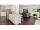 Open kitchen with stainless steel refrigerator and a view to the living room at 19606 N 23Rd Way, Phoenix, AZ 85024