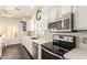 Well-lit kitchen boasting stainless steel appliances, and white cabinetry at 19606 N 23Rd Way, Phoenix, AZ 85024
