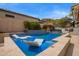 Resort style pool with a waterfall feature and submerged loungers with blue tile and patio at 19606 N 23Rd Way, Phoenix, AZ 85024