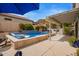 Backyard pool with hot tub, submerged loungers, table under an umbrella and patio at 19606 N 23Rd Way, Phoenix, AZ 85024