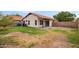 Spacious backyard featuring a partial patio and view of the home's exterior at 2027 S Rowen St, Mesa, AZ 85209