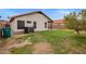 Spacious backyard featuring a partial patio and mature landscaping at 2027 S Rowen St, Mesa, AZ 85209