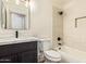 Bathroom featuring black fixtures, neutral walls, vanity, toilet, and shower with tub at 2027 S Rowen St, Mesa, AZ 85209
