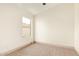 Bright bedroom featuring neutral walls, carpet, and square window overlooking the exterior at 2027 S Rowen St, Mesa, AZ 85209