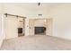 Open bedroom with a barn door to the bathroom and an entrance to the kitchen at 2027 S Rowen St, Mesa, AZ 85209