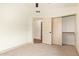 Bedroom features neutral walls and carpet, closet, and doorway to additional rooms at 2027 S Rowen St, Mesa, AZ 85209